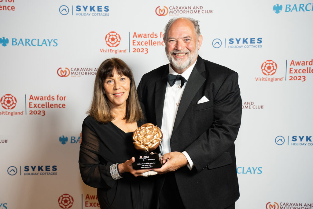 Chrissie and Max Parker holding gold award as Best B&B and Guest House of the year received at the Visit England Excellence Awards